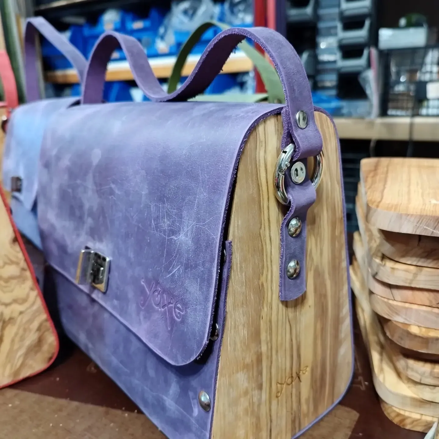 Purple oil leather top handle bag and olive treee wood